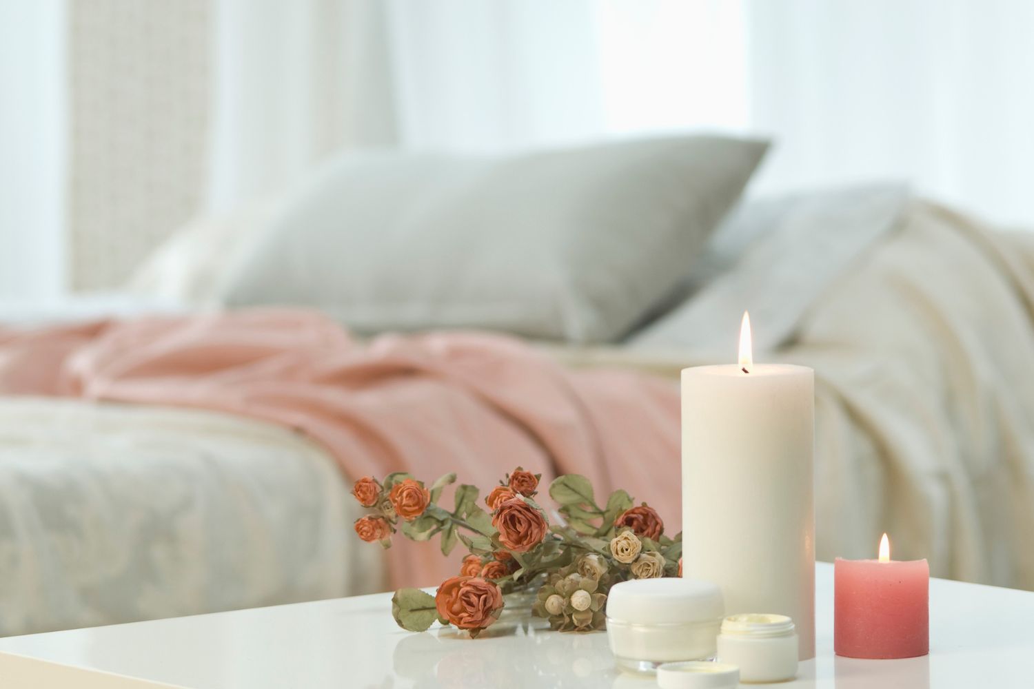 Set the scene with comfy bedding and some candles.
