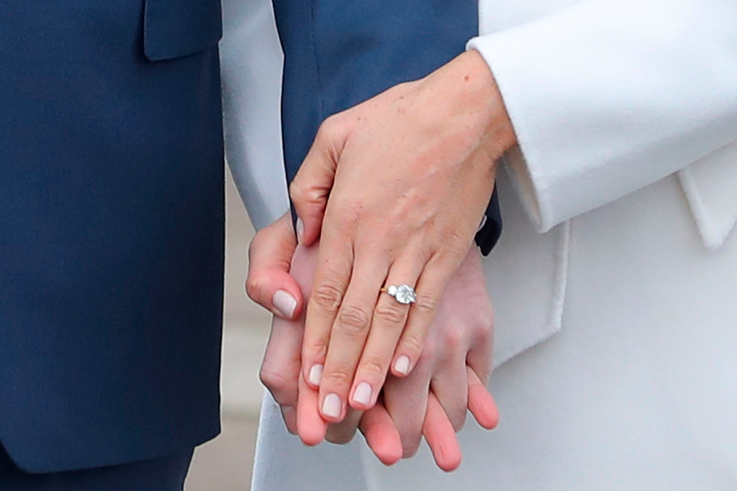 Prince Harry stands with his fiancée US actress Meghan Markle as she shows off her engagement ring