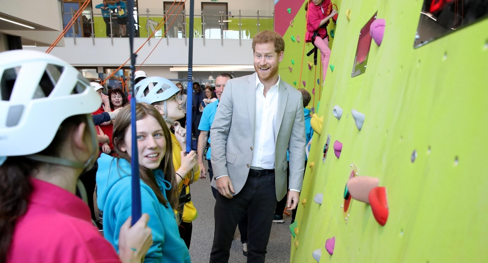 Prince Harry shows his support for young rock climbers