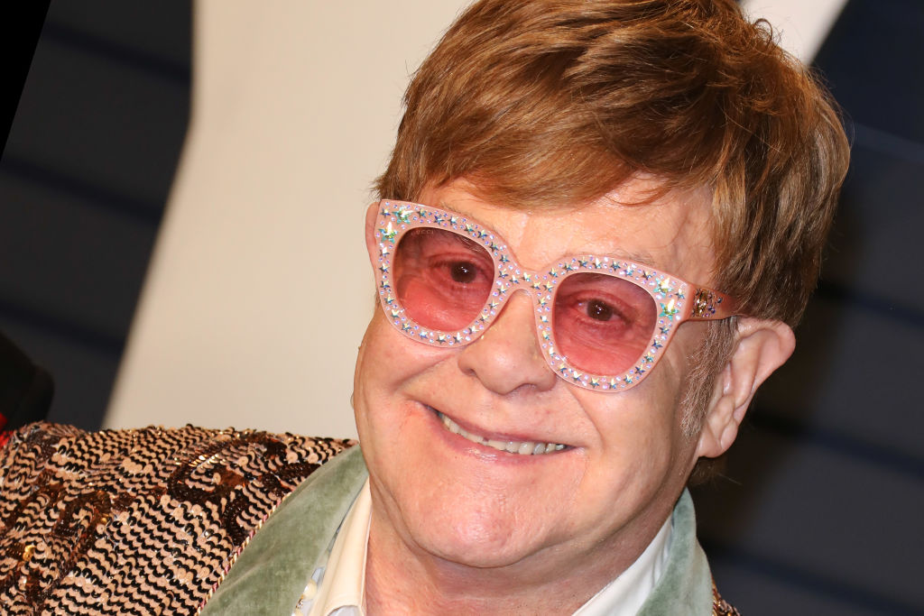 Elton John wearing pink glasses
