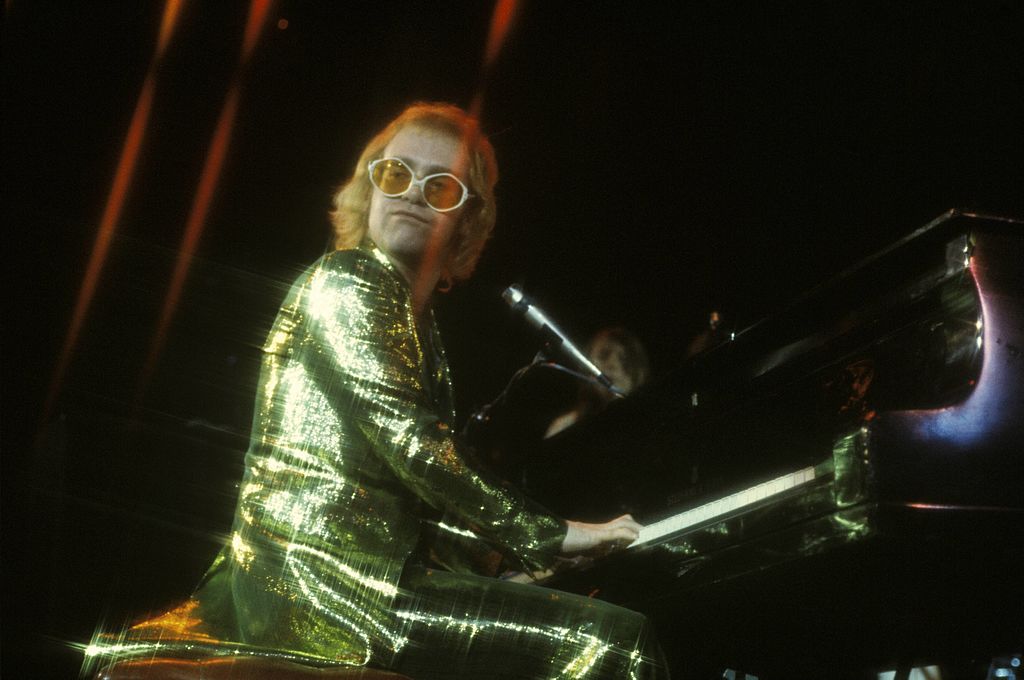 Elton John wears yellow glasses