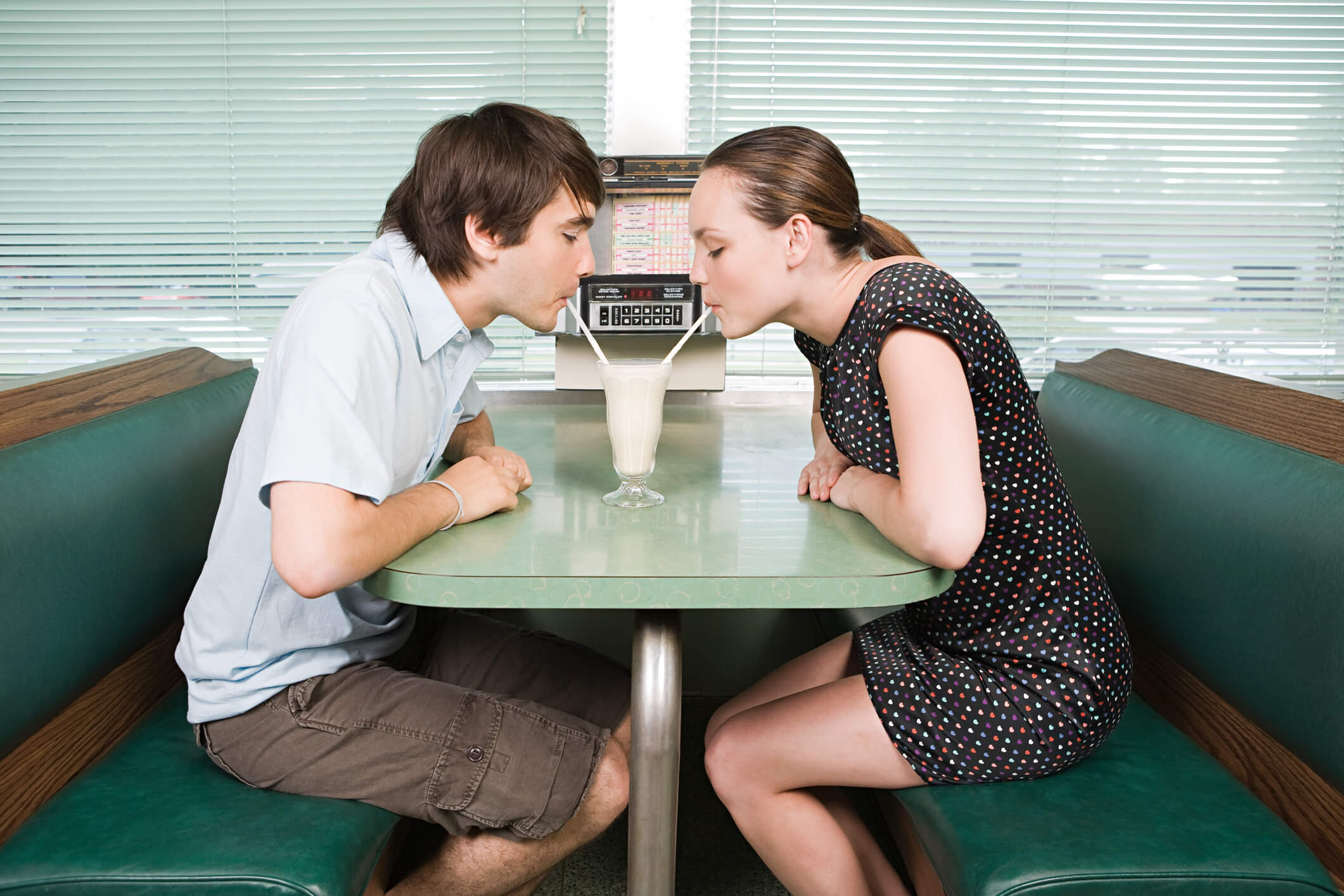 A couple having a milkshake at a milk bar