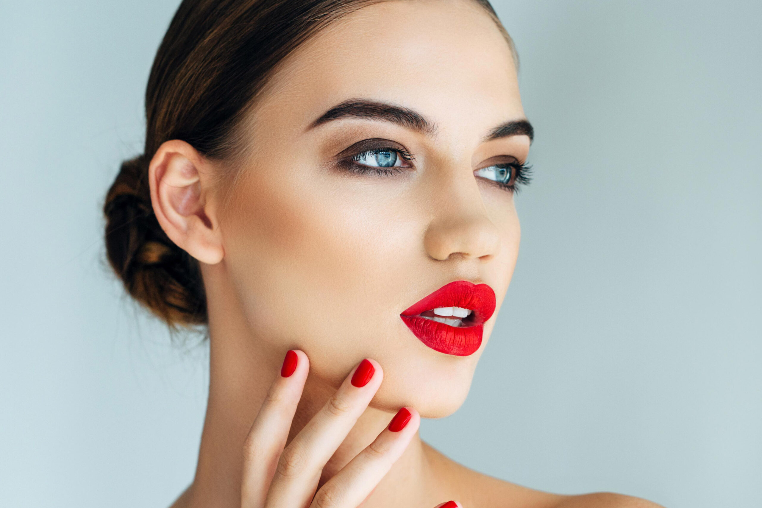 Woman with red lipstick and nails