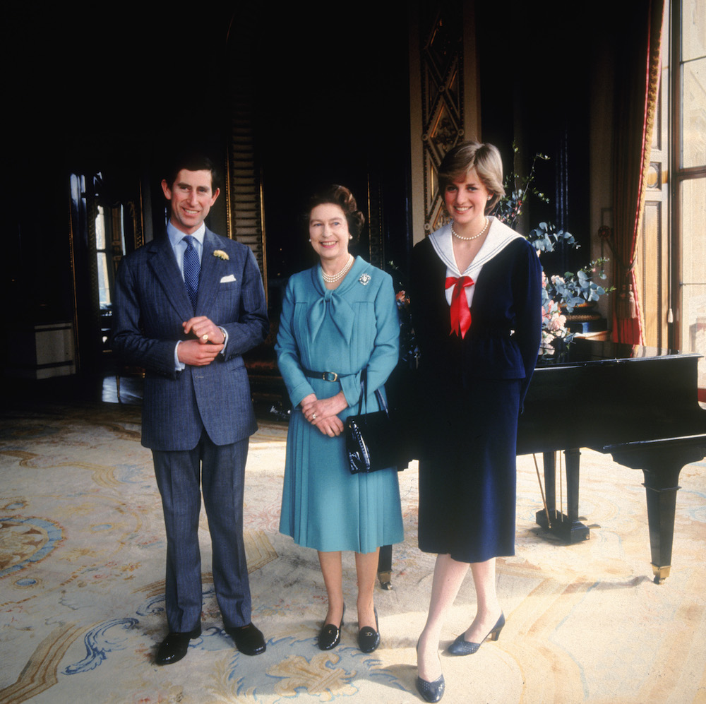 Queen Elizabeth poses with her son Prince Charles and his fiancée Lady Diana Spencer to announce their engagement in 1981