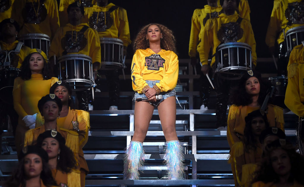 Beyonce wearing a yellow hoodie at Coachella 2018