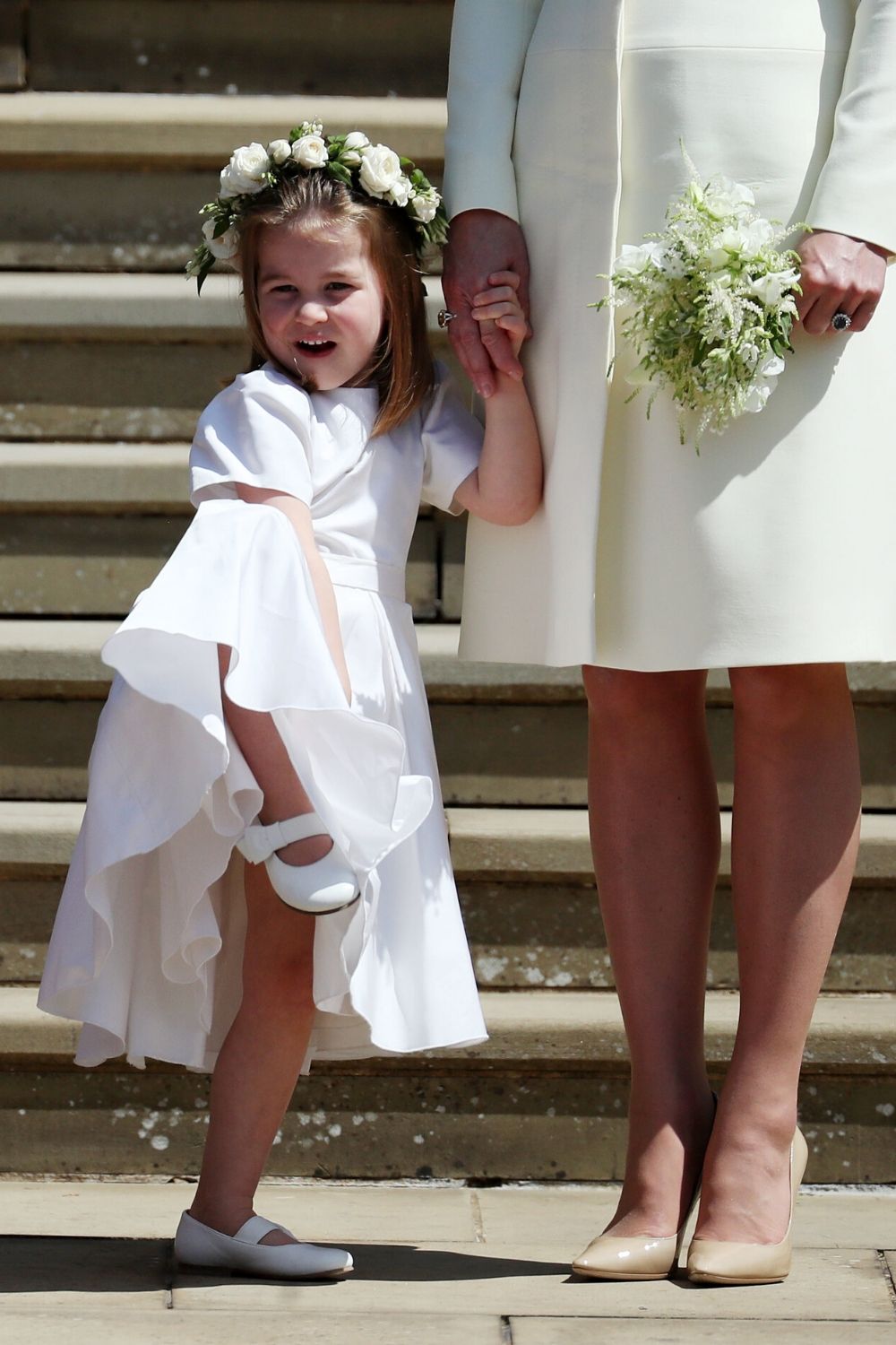 Princess Charlotte posing at Harry and Meghan's wedding in 2018.