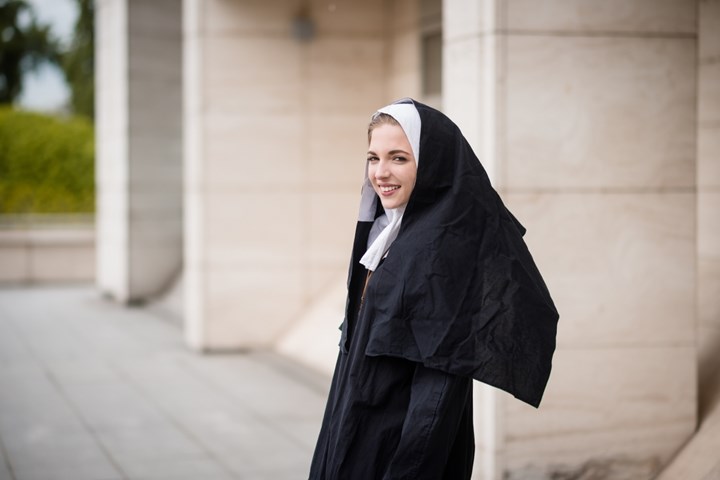 A young nun looking at the camera