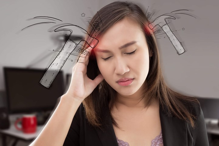 A woman wincing due to a headache with small hammers drawn on each side of her head
