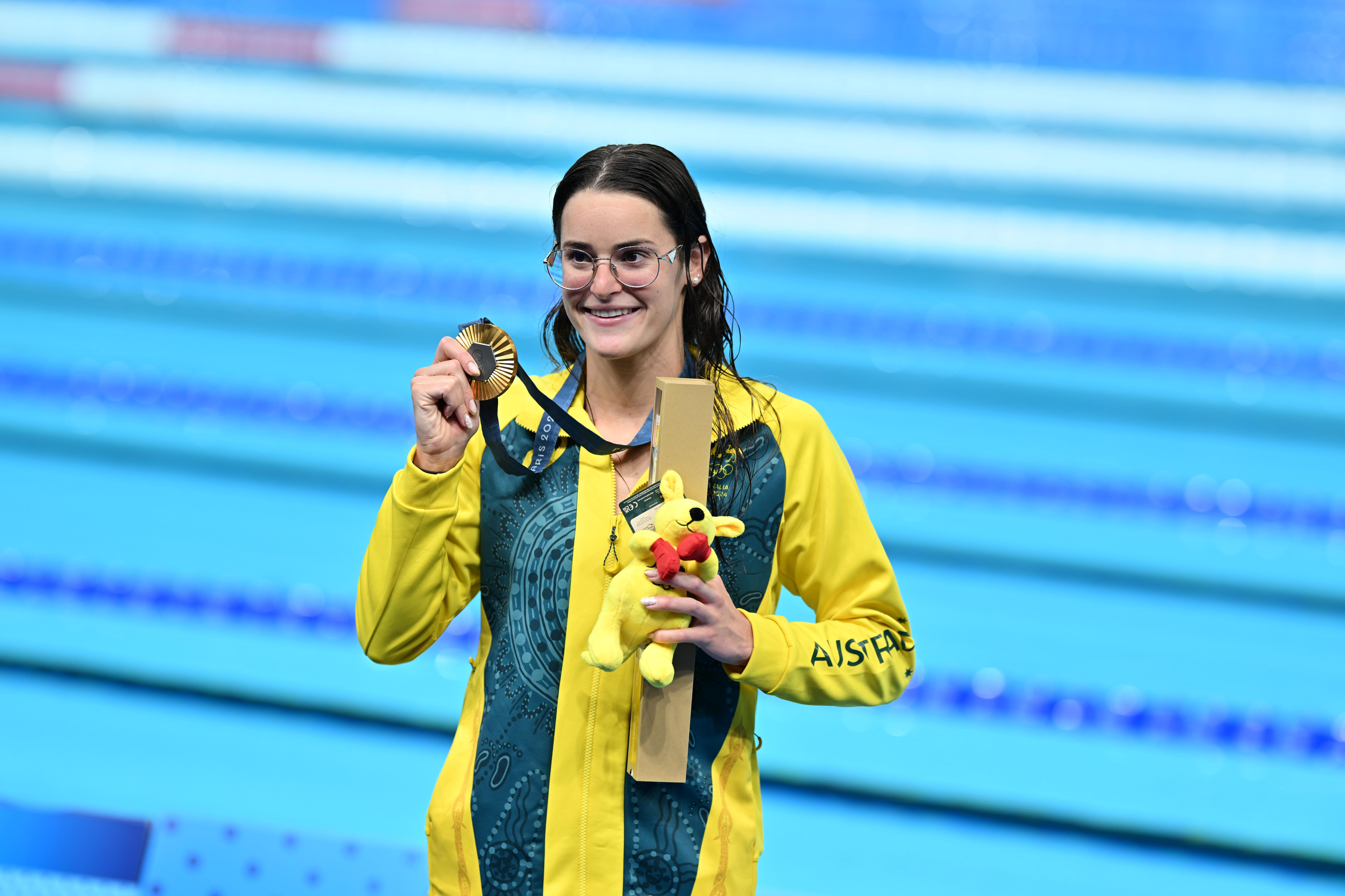PARIS, FRANCE - JULY 30: Gold medallist Australia's Kaylee McKeown, silver medallist US' Regan Smith (not seen) and bronze medallist US' Katharine Berkoff (not seen) pose for a photo with their medals on the podium of the women's 100m backstroke swimming event during the Paris 2024 Olympic Games at the Paris La Defense Arena in Nanterre, west of Paris, France on July 30, 2024. (Photo by Mustafa Yalcin/Anadolu via Getty Images)