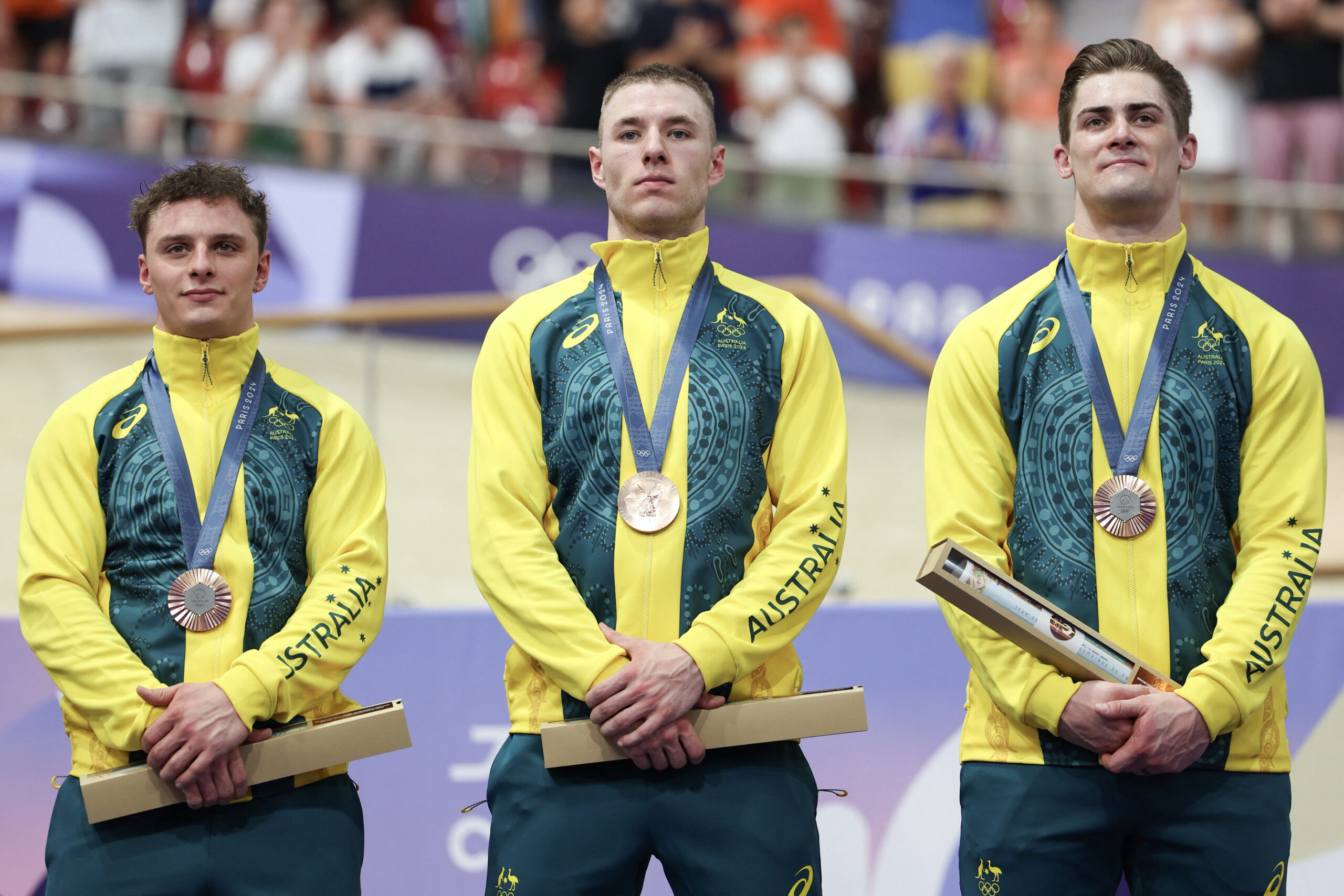 Australia's Matthew Richardson (L), Australia's Leigh Hoffman (C) and Australia's Matthew Glaetzer (R) celebrate their bronze medal on the podium after the men's track cycling team sprint event of the Paris 2024 Olympic Games at the Saint-Quentin-en-Yvelines National Velodrome in Montigny-le-Bretonneux, south-west of Paris, on August 6, 2024. (Photo by Thomas SAMSON / AFP) (Photo by THOMAS SAMSON/AFP via Getty Images)