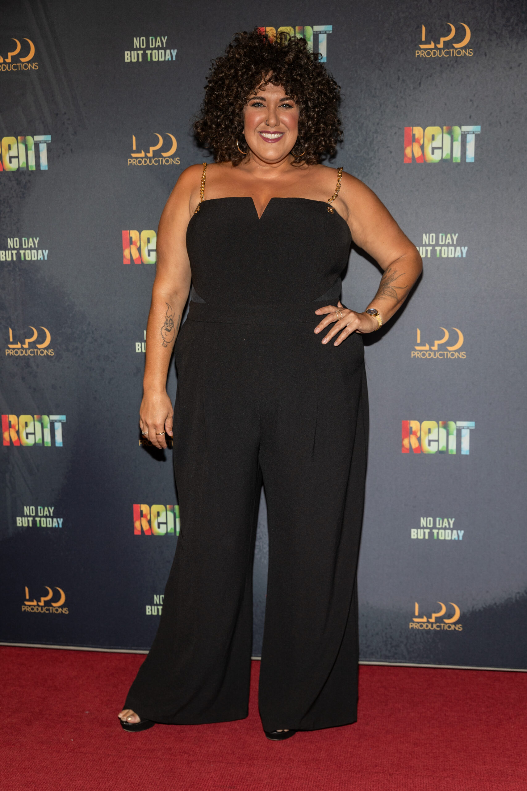Casey Donovan wearing a black jumpsuit.