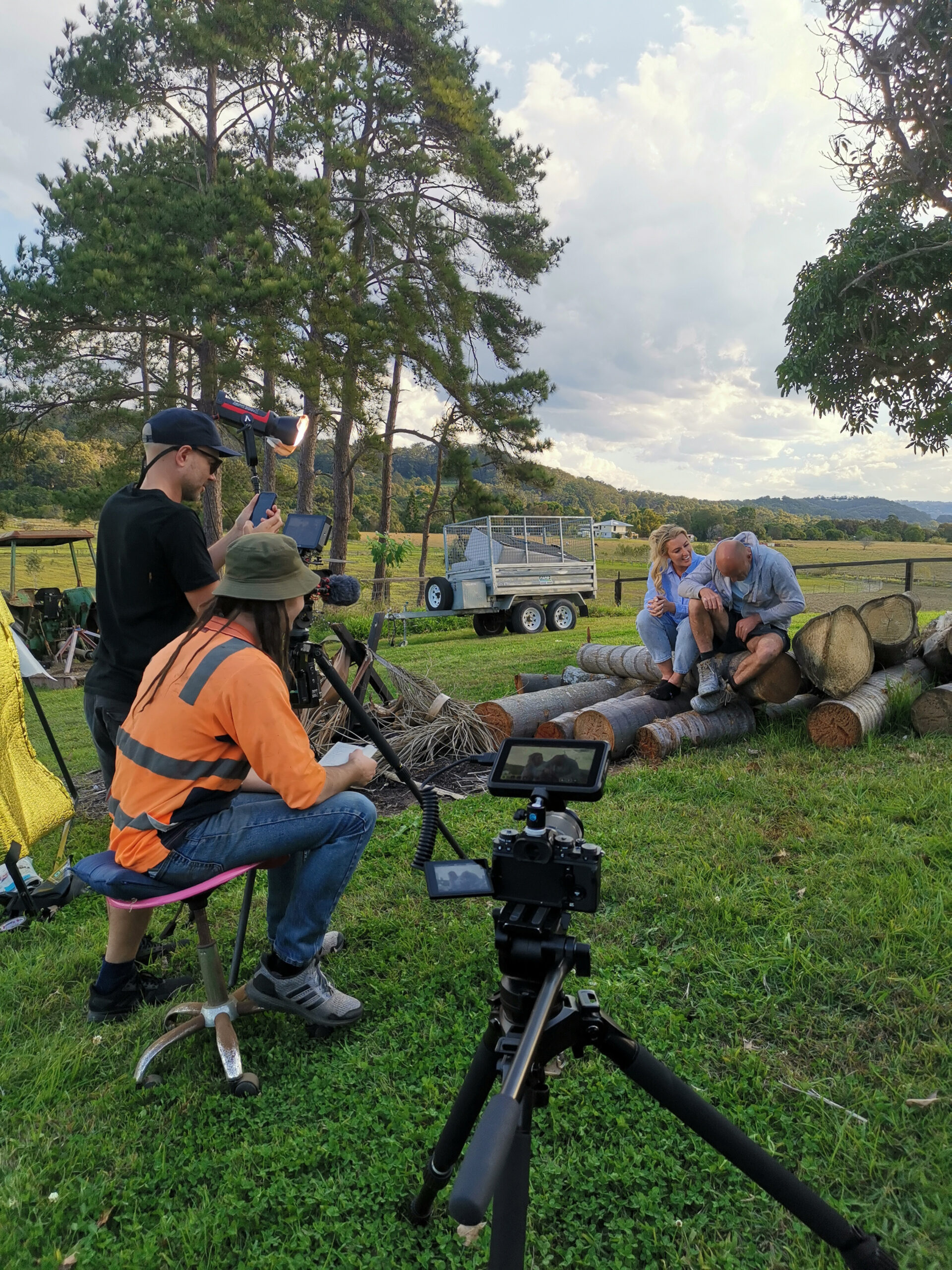 Jess Eva and Norm Hogan outdoors filming for their TV show Budget Battlers.